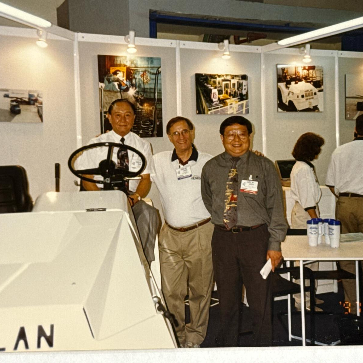 Vintage trade show exhibit featuring the Harlan tractor, documenting a legacy of global industrial leadership and pioneering innovation in ground support equipment.