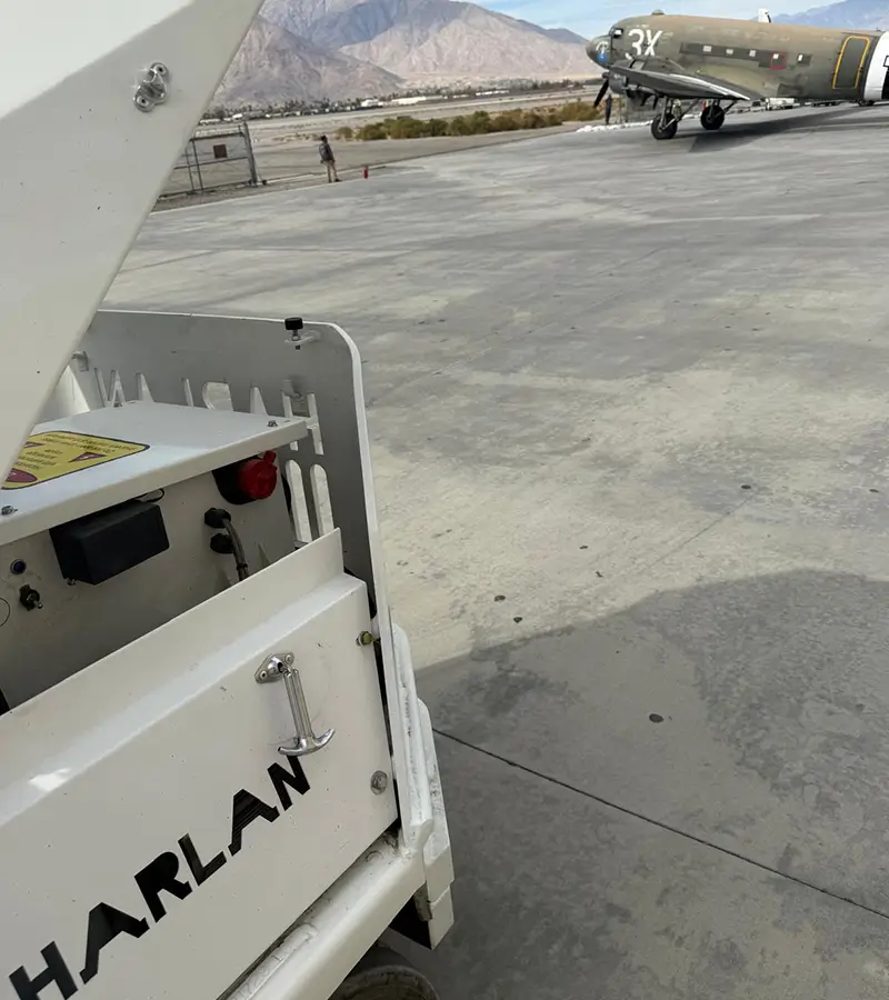 Electric ground support vehicle operating with zero emissions on an airport tarmac.