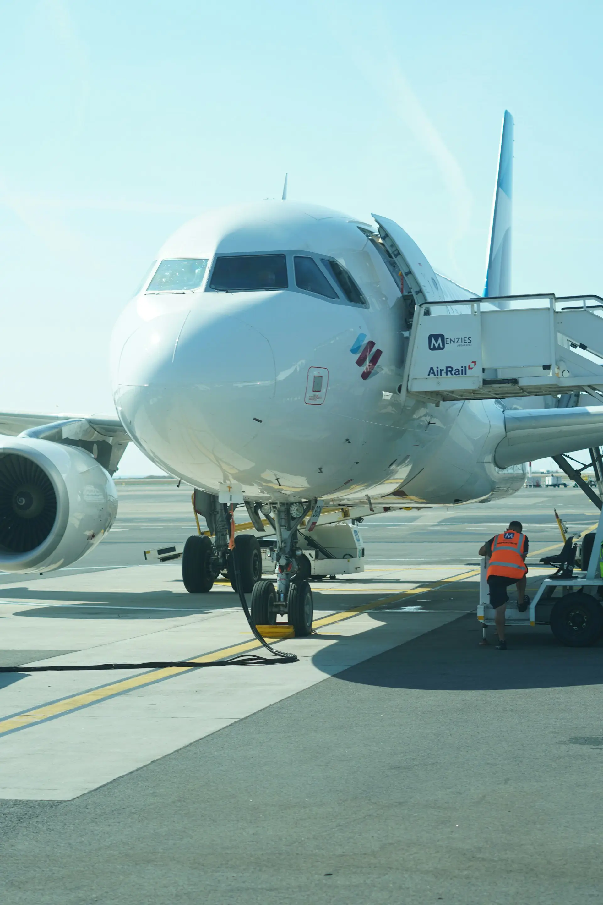 Technician performing maintenance on low-cost electric GSE.